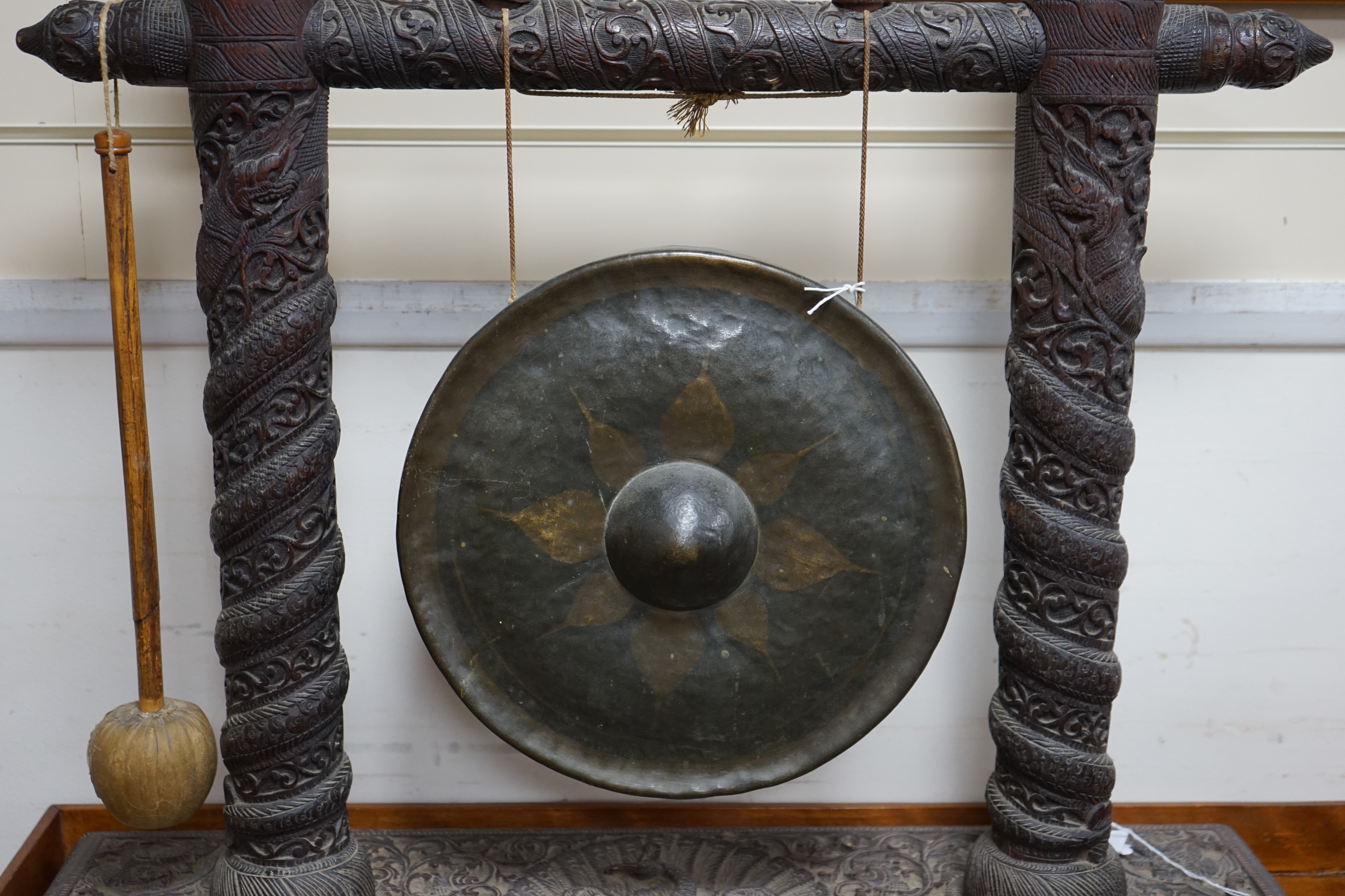 An Indian hardwood framed dinner gong